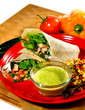 Chicken Fajitas with tomatoes, sauce and salad on plate. Chicken Fajitas with tomatoes, sauce and salad on plate.