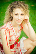 Close-up portrait of beautiful young woman on green field in sum Close-up portrait of beautiful young woman on green field in sum