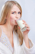 Pretty blond girl drinking milk