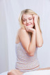 Cute smiling girl on bed waking up in bedroom