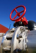 industrial piping and red valve against blue sky