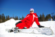Happy young mountain skier resting on the slope