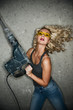Beautiful blond woman with heavy perforator in her hands