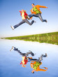 Happy young couple jumping in sky above a green meadow Happy young couple jumping in sky above a green meadow