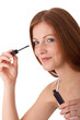 Body care series - Smiling red hair woman applying mascara