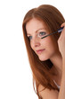 Body care series - Beautiful red hair woman applying mascara