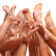 Beautiful female slim feet of group of girls