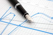 fountain pen on business chart