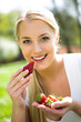 Photo: Woman eating strawberries Woman eating strawberries