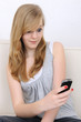 girl receives a sms and smiles surprised girl receives a sms and smiles surprised