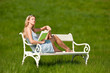 Blond woman in blue dress enjoying sun