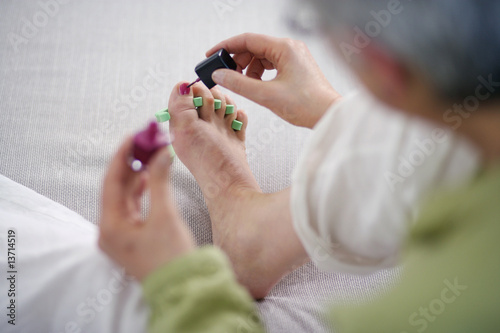 Photo: Senior woman giving herself at pedicure at home Senior woman giving herself at pedicure at home