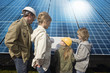 Foto: Family looking at plans laid on solar panels in Munich, Bavaria, Germany Family looking at plans laid on solar panels in Munich, Bavaria, Germany