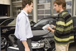 Insurance adjuster assessing damage to car