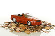 Red toy car on coins
