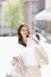 Photo: Young woman talking on cell phone, outdoors, Stuttgart, Baden-Wurttemberg, Germany Young woman talking on cell phone, outdoors, Stuttgart, Baden-Wurttemberg, Germany