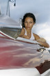 Young woman in convertible car, looking away, Havana, Cuba