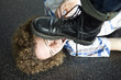 Photo: Young man lying on ground about to be stepped on Young man lying on ground about to be stepped on