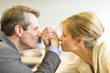 Mature man and woman enjoying a friendly bout of arm wrestling