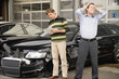 Insurance adjuster assessing damage to car