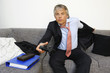 Portrait of businessman playing video games, studio shot