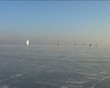 Ice sailing and skating on the Gouwzee in the Netherlands