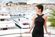 Beautiful model on the balcony with marina background