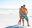 Rear view image of a young couple at the beach