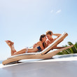 Relaxed couple on a deck chair together