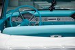 Dashboard of a classic blue and white 1956 convertible car