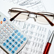 Financial report - calculator, glasses and papers