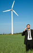 businessman shaving on meadow with ecology wind power
