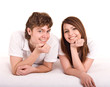 Happy young family on bed.