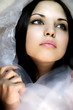 girl with dark blue eyes in a silk scarf