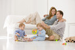 Parents with their son and a daughter in a living room