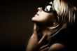 Fashion woman portrait wearing sunglasses on dark background Fashion woman portrait wearing sunglasses on dark background