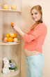 Pregnant woman eating fruit