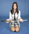 Girl sitting in a lap stretches us a sword