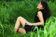black haired girl woman in green fresh spring summer grass
