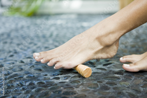 Photo: Woman massaging her foot with a foot roller Woman massaging her foot with a foot roller