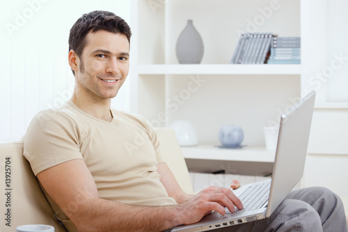 Photo: Happy man using computer Happy man using computer