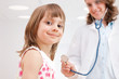 Female doctor examining happy child