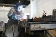 Factory worker welding metal