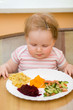 Foto: The child eats a vegetable salad The child eats a vegetable salad