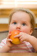 Cute little baby eating an apple