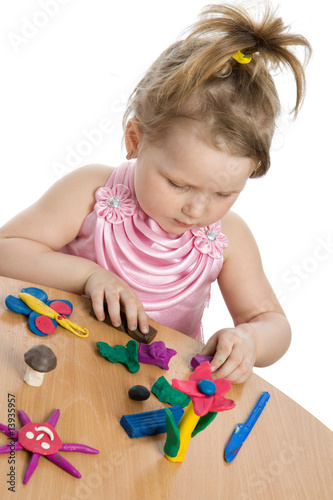 Photo: Cute girl playing with color play plasticine Cute girl playing with color play plasticine
