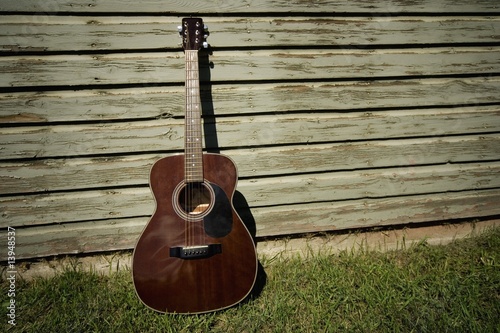 Photo: Acoustic guitar leaning against building Acoustic guitar leaning against building