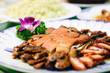 sliced roasted pork on white plate decorated with orchid sliced roasted pork on white plate decorated with orchid