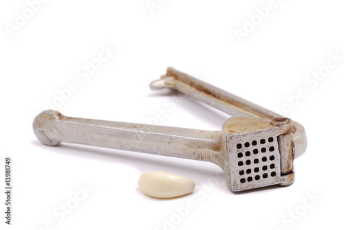 Photo: Garlic clove and crusher Garlic clove and crusher
