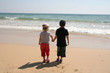 Children holding hands looking to sea Children holding hands looking to sea